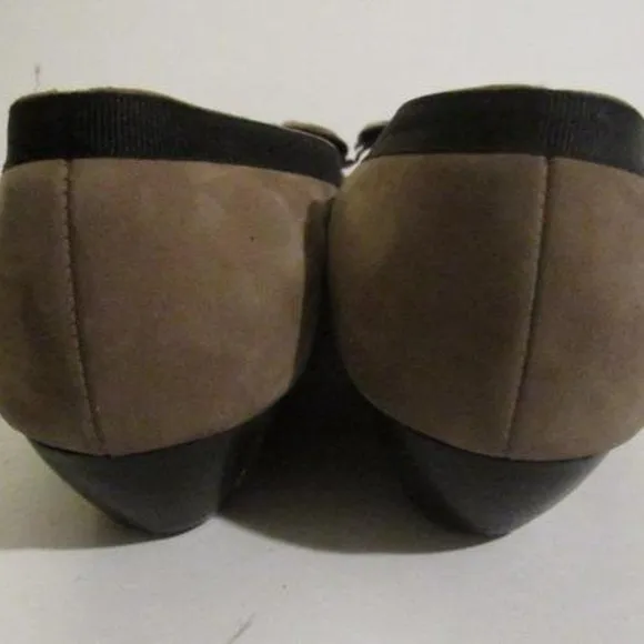 Salvatore Ferragamo VARA brown suede flats with black trim, large, fringe bows at the toes, and low, wedge heels
