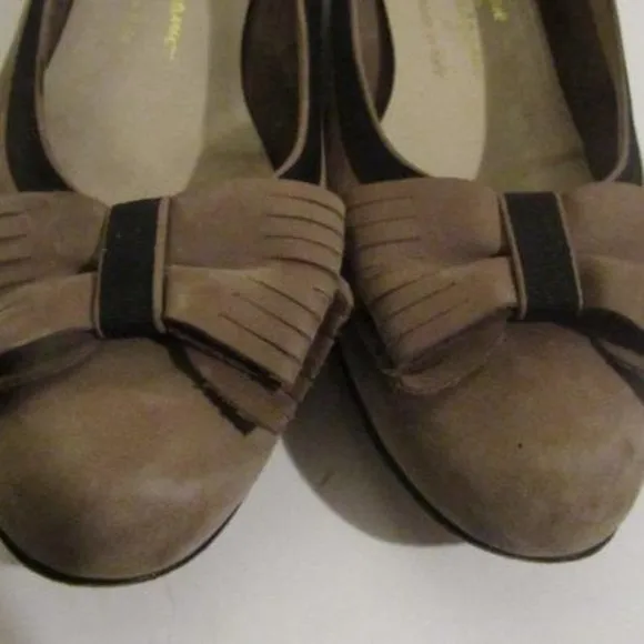 Salvatore Ferragamo VARA brown suede flats with black trim, large, fringe bows at the toes, and low, wedge heels